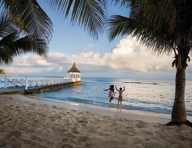 Two kids jumping on the beach