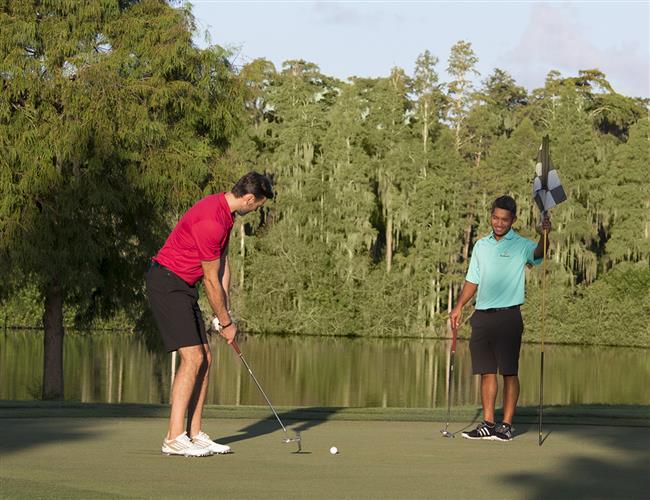 Golfer putting on the green