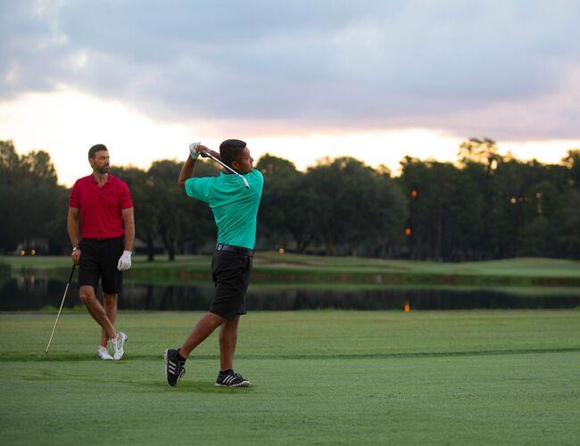 Two golfers playing golf