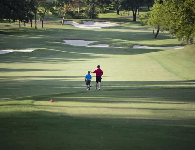 Father and son walking on Golf Course
