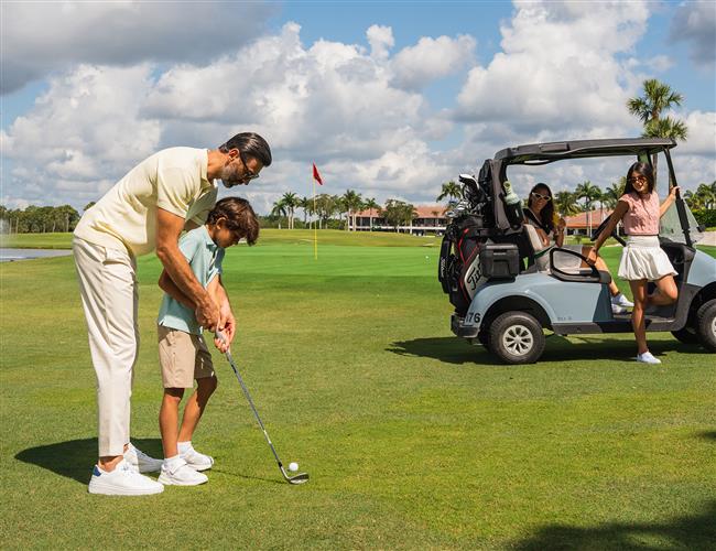 Father teaching son golf