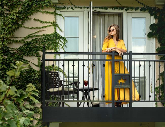 Woman standing on the balcony of a guestroom