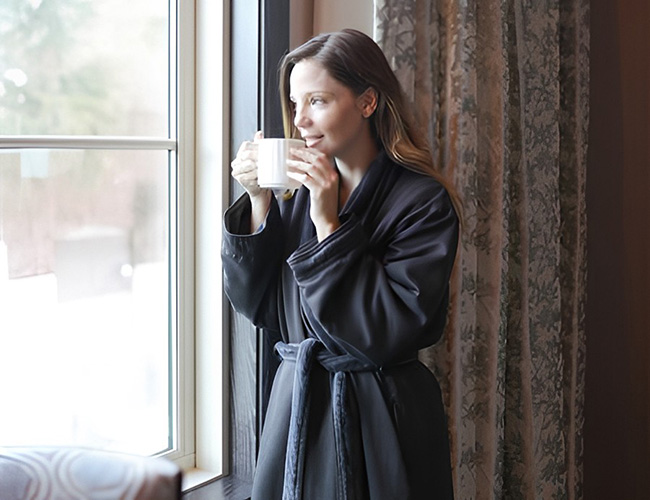 lady drinking tea by window