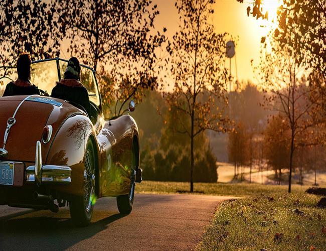 two people driving in classic car