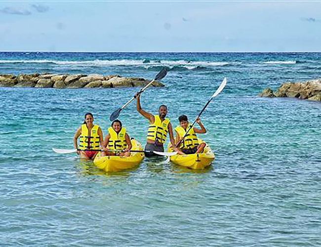 A group kayaking in the ocean. 