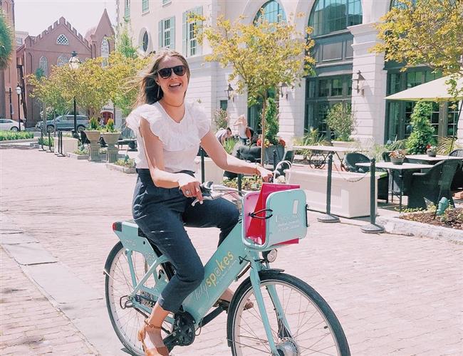 A woman riding a bike on street of Middleburg