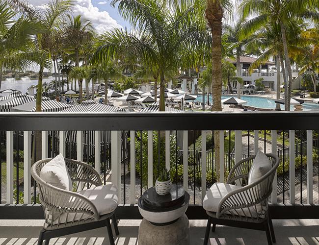 A balcony overlooking a pool