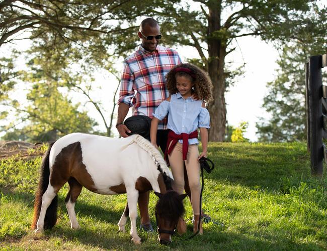 Father and daughter with Cupcake the mini pony