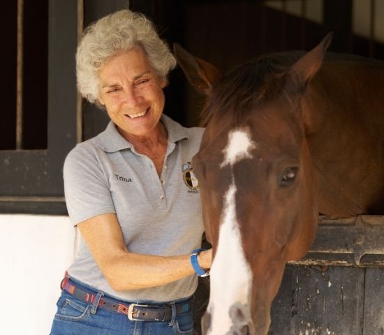woman petting a horse