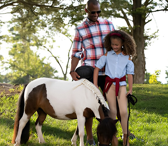 Family petting a pony
