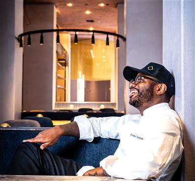 Chef smiling in a booth