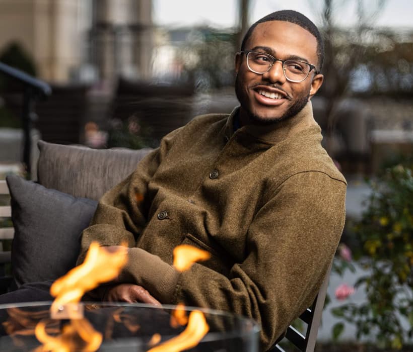 Kwame Onwuachi by a fire pit