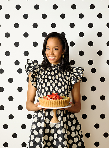 Maya-Camille Broussard holding a strawberry graham cracker pastry