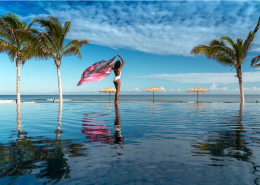 Half Moon infinity pool with palm trees