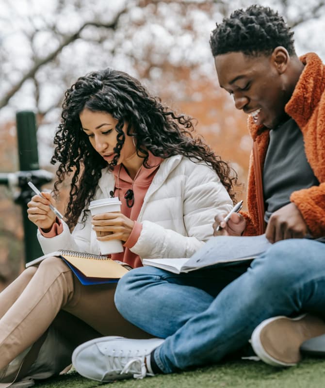 Two students studying outdoors