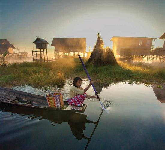 Girl rowing down river