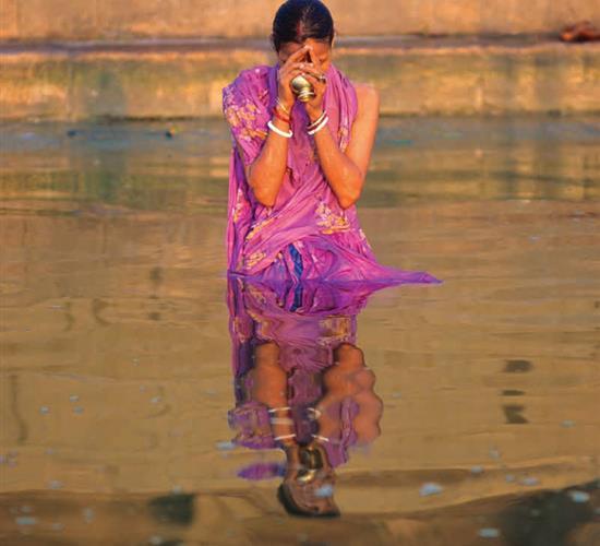 woman praying in water