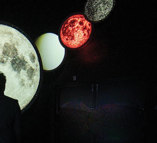 man viewing the planet alignment art installation