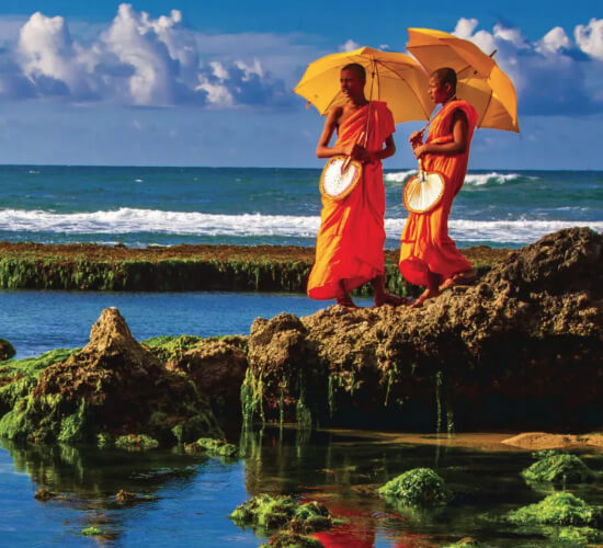 Two monks standing at the tide pool