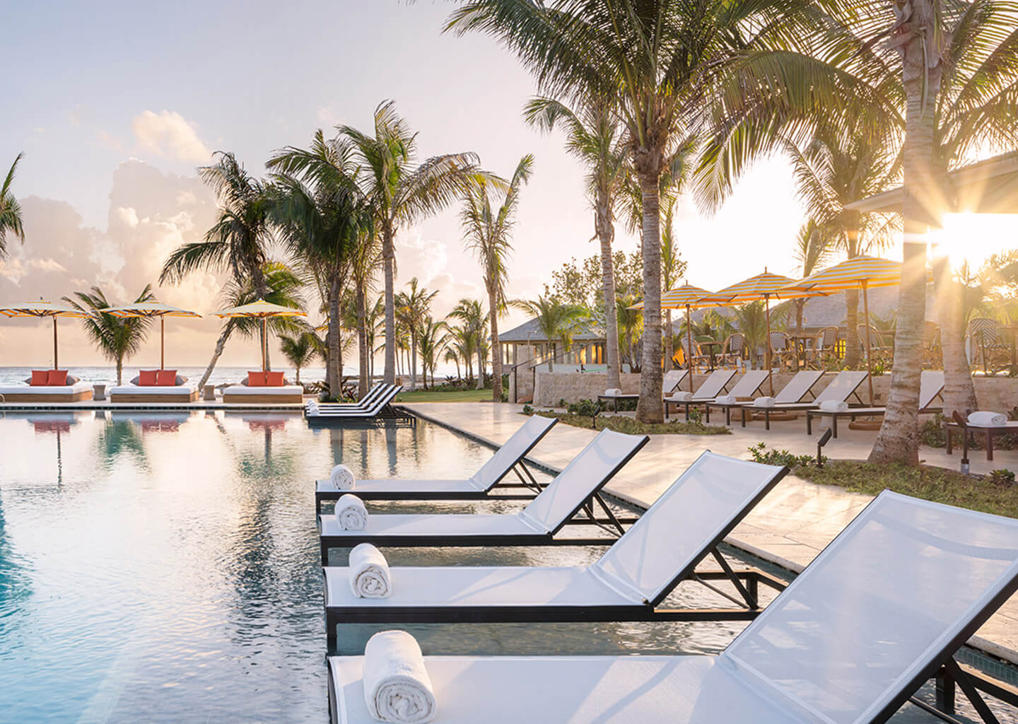 Pool with modern lounge chairs with personal towels