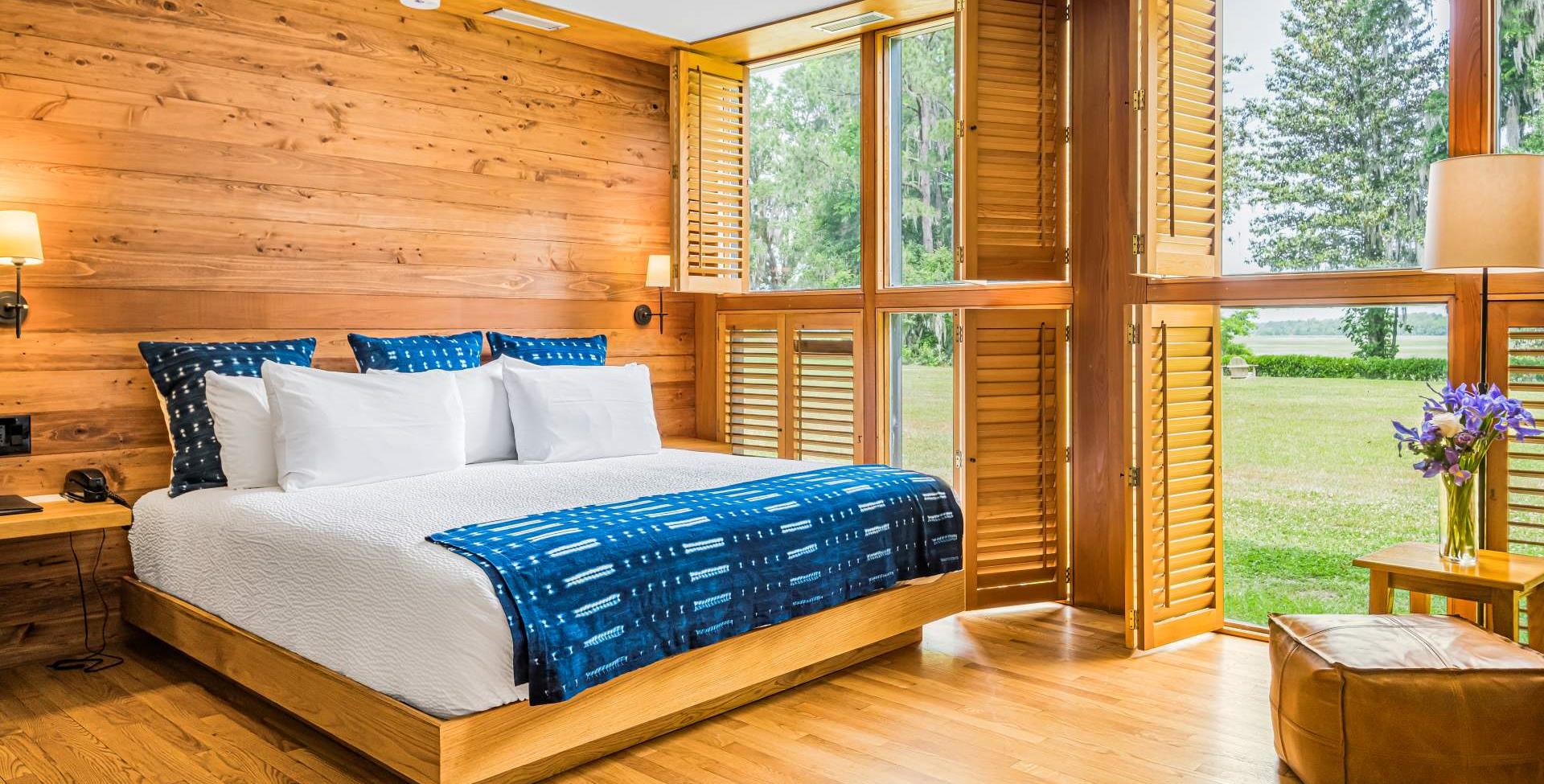 A wooden room with a white bed