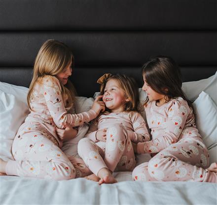 Kids playing on the bed