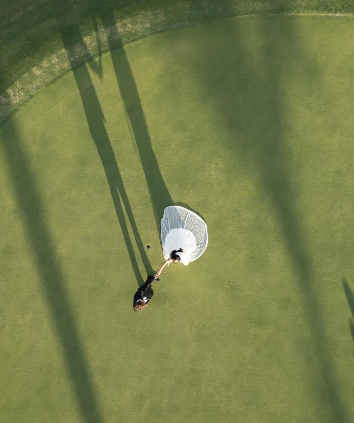 A bride and groom on a golf course