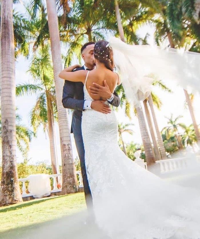 A bride and groom standing next to one another