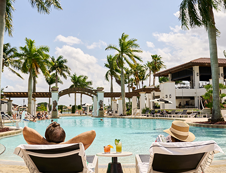 Couple lounging poolside