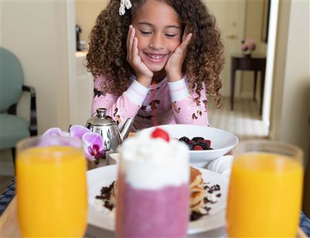 Young girl enjoys a meal in her pajamas