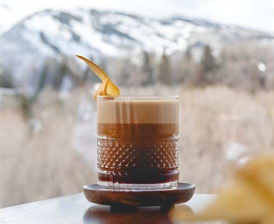 A drink with mountains behind it