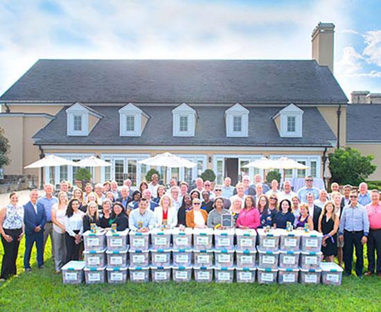 People gathered in front of a house for a photo