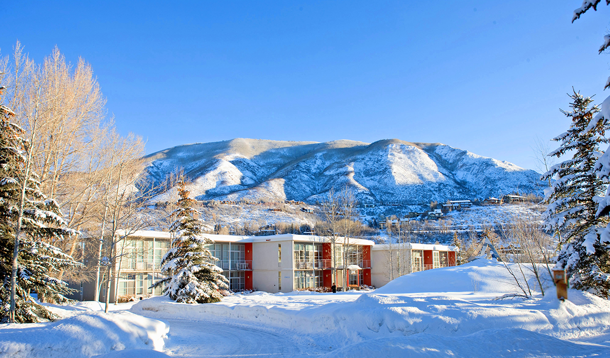Snowy mountains and guest rooms at Aspen Meadows Resort