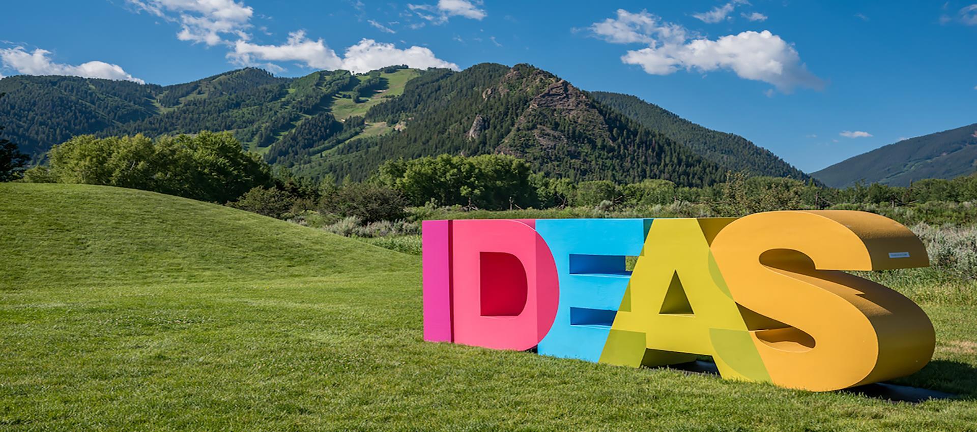 Ideas sculpture with mountains in background